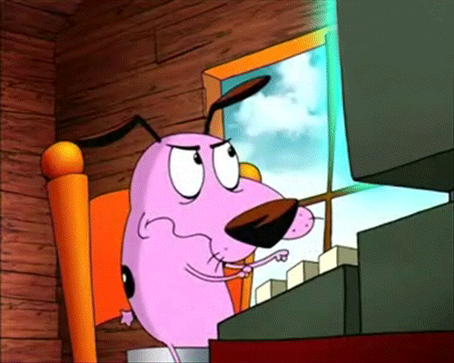 courage the cowardly dog typing on a keyboard while glaring at a glowing blue monitor